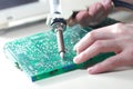 Engineer repair circuit board with Electric Vacuum Solder Sucker Royalty Free Stock Photo