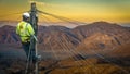 Engineer Repairing A Desert Telephone Line Royalty Free Stock Photo