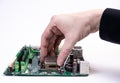 Engineer repairman holding hands in black gloves chip processor, CPU to insert into the socket of the computer motherboard. The