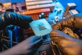 Engineer repairman holding hands CPU to insert into the socket of the motherboard. Technology hardware in the neon light