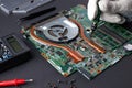 Engineer repairs laptop motherboard. Laptop troubleshooting