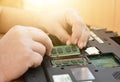 Engineer restores the laptop PC. Installing the hard drive hardware, RAM. Electronic repair shop, technology renovation