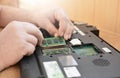 Engineer restores the laptop PC. Installing the hard drive hardware, RAM. Electronic repair shop, technology renovation