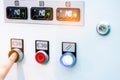 Engineer`s hand push green button to open temperature control machine. Temperature control panel cabinet contain digital screen Royalty Free Stock Photo