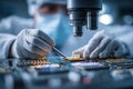 Engineer\'s hands adjusting microchips under a microscope in a lab setting Royalty Free Stock Photo
