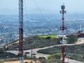 Engineer with safety equipment on high tower for working telecom communication maintenance.