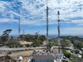 Engineer with safety equipment on high tower for working telecom communication maintenance.