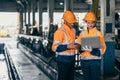 Engineer safety officer team man and women working together with laptop checking inspect in heavy industry building factory Royalty Free Stock Photo