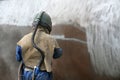 Engineer sandblasting a steel casing