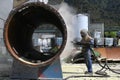 Engineer sandblasting a steel casing