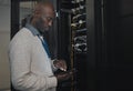 Engineer, server room or black man with tablet for database connection cable, maintenance or software update at night