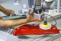 The engineer setup and teaching the automatic polishing robotic system in the automotive assembly line with control pad.