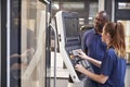 Engineer Showing Apprentice How To Use CNC Tool Making Machine Royalty Free Stock Photo