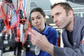 engineer showing apprentice how to use machine Royalty Free Stock Photo