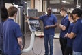 Engineer Showing Apprentices How To Use CNC Tool Making Machine Royalty Free Stock Photo