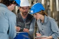 engineer showing nut and bolt to woman with notepad Royalty Free Stock Photo