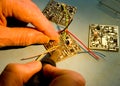 Engineer soldering wires to a circuit board. Royalty Free Stock Photo