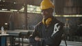 Engineer standing holding wrench tools and arms crossed at work in the industry Royalty Free Stock Photo