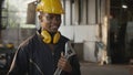 Engineer standing holding wrench tools and arms crossed at work in the industry Royalty Free Stock Photo