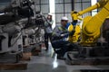 Engineer standing by robotic arm and operating machine in industry factory Royalty Free Stock Photo