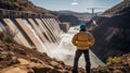 An engineer stands in front of a dam Royalty Free Stock Photo