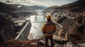 An engineer stands in front of a dam Royalty Free Stock Photo