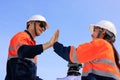 engineer and surveyor engineers high five after work at road construction site, angle shot Royalty Free Stock Photo