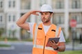 Engineer with tablet, building inspection. Builder at building site. Construction manager or engineer in helmet outdoor Royalty Free Stock Photo