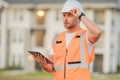 Engineer with tablet, building inspection. Builder at construction site. Buider with helmet on construction outdoor Royalty Free Stock Photo