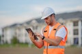 Engineer with tablet, building inspection. Construction man in helmet build new house. Engineer work in builder uniform Royalty Free Stock Photo