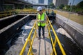 Engineer take water from wastewater treatment pond to check the quality of the water. After going through the wastewater treatmen