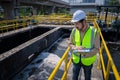 Engineer take water from wastewater treatment pond to check the quality of the water. After going through the wastewater treatmen