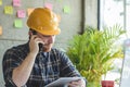 Engineer talking with phone and looking at tablet Royalty Free Stock Photo