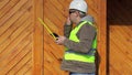 Engineer with a tape measure and cell phone