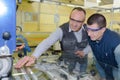 engineer teaching apprentice to use grinding machine Royalty Free Stock Photo