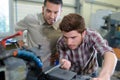 engineer teaching apprentice to use grinding machine Royalty Free Stock Photo