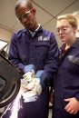 Engineer Teaching Apprentice To Use Grinding Machine Royalty Free Stock Photo