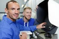 Engineer teaching apprentice to use machine Royalty Free Stock Photo