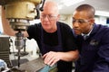 Engineer Teaching Apprentice To Use Milling Machine Royalty Free Stock Photo