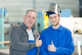 Engineer teaching apprentice to use tig welding machine Royalty Free Stock Photo