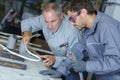 Engineer teaching apprentice to use tig welding machine Royalty Free Stock Photo