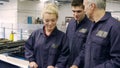 Engineer Teaching Apprentices To Use Tube Bending Machine