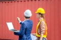 Engineer team with laptop and clipboard checklist checking containers box from cargo, Logistic and teamwork concept Royalty Free Stock Photo