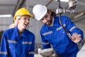 Engineer team man and woman working together training help support work with robot welding machine service Royalty Free Stock Photo