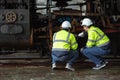 Engineer team service maintenance old broken diesel steam train park at railway depot team working with safety suit