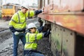 engineer team service maintenance old broken diesel train park at railway depot team working with safety suit Royalty Free Stock Photo