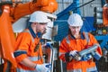 engineer team worker working program robot arm assembly machine in modern metal heavy industry factory Royalty Free Stock Photo