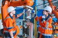 engineer team worker working with robot arm assembly machine in modern metal heavy industry factory Royalty Free Stock Photo