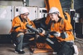 engineer team working together training new staff worker to operate hand control robot arm welding machine in automation factory Royalty Free Stock Photo