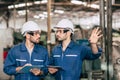 Engineer teamwork cooperate with worker to checking factory machine for safety and talking together